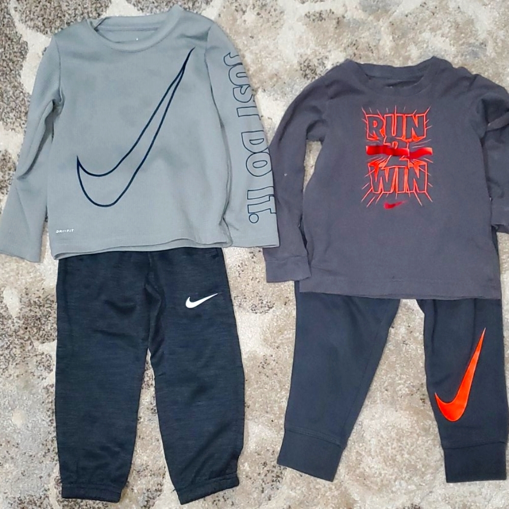 2 Nike sweatpants with long sleeve T-shirts.